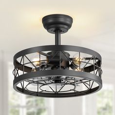 a ceiling fan that is hanging from the ceiling in a room with white walls and windows