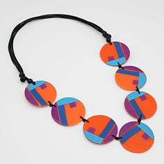 "Make a bold statement with our eye-catching poppy necklace from Sylca Designs. Featuring acrylic beads in orange and blue, this statement necklace is both vibrant and versatile, perfect for dressing up or down. Its adjustable wax cord ensures a comfortable fit, and its lightweight design makes it easy to wear all day long. Adjustable Length: 24\"- 32\" Bead Width: 1.5\" Made to Match: LS23E14 ORANGE  Care Instructions: Remove jewelry when applying perfumes, creams, washing hands, etc. Do not st Retro Orange Necklace Gift, Bold Multicolor Adjustable Necklace, Vibrant Orange Handmade Necklace, Modern Orange Necklace As Gift, Modern Orange Necklace For Gift, Bold Multicolor Beaded Necklaces, Adjustable Long Orange Necklace, Vibrant Orange Necklace For Gift, Poppy Necklace