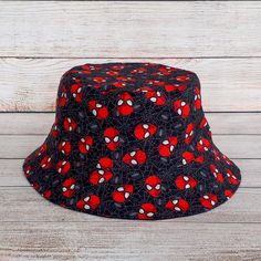 "Black Spider Superhero Bucket Hat - Reversible Cotton Unisex One Size fits most. Soft flexible structure, easygoing aesthetic style made with a 100% Cotton fabric in a funky and colourful print allows the wearer to create their own individual fashion statement and show their Superhero pride for Spiderman! One size - fits 21.5\" - 23\" head. Will be a loose fit on a 21.5\", tighter fit on 23\" 3 1/2\" Height from 2.25\" Interfaced Brim 100% Printed Quilting Quality Cotton fabric & 100% Solid Bla Easygoing Aesthetic, Spiderman Hat, Kids Bucket Hat, Superhero Gifts, Birthday Presents For Him, Black Spider, Cotton Hat, Aesthetic Style, Presents For Him