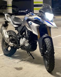 a white and blue motorcycle parked in a parking lot