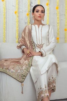 An ethereal Raw Silk ensemble featuring minimal zardozi embroidery beautifully contrasted with Rose Gold dupatta featuring beads, sequins, pearls, dabka, resham, cutwork and contrasting applique work details, finished with handmade tassels. This outfit is paired with cutwork and appliqued work hand embroidered culottes to complete the look. Shirt Fabric: Pure Raw Silk Shirt Color: Ivory Shirt Length: 40" Pant Fabric: Pure raw silk Pant Color: Ivory Dupatta Fabric: Pure Soft Tissue Dupatta Color: Designer Outfit, Pakistani Wedding Outfits, Kurti Neck, Pakistani Dresses Casual, Pakistani Fashion Party Wear, Salwar Kamiz, Desi Clothes, Pakistani Bridal Dresses, Simple Pakistani Dresses