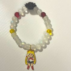 Sailor Moon, White Black Flower, Charm Bracelet With Yellow And Red Beads Sailor Moon Bracelet, Sailor Moon Accessories, Flower Charm Bracelet, Moon Accessories, Moon Bracelet, Red Beads, Black Flower, Red Bead, Flower Charm