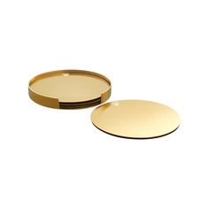 two round gold trays sitting side by side on a white surface, with one empty