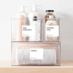 two clear containers holding personal care items on a table