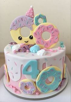 a birthday cake decorated with donuts and sprinkles