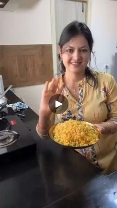 a woman holding a plate full of food