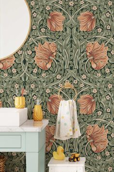 a bathroom with green and orange wallpaper and a mirror on the wall next to a sink