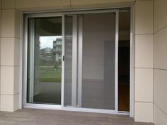 an open sliding glass door on the side of a building