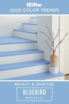 a blue and white staircase with a vase on it