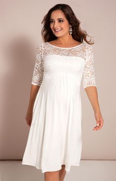 Beautifully designed using bold stretch floral lace, our Lucia short all white maternity dress is super luxurious. You’ll love the simple elegance of the lace sleeves and bodice combined with our finest heavyweight micro modal fabric that exudes bridal style. The knee length skirt has a gentle swish to it while the sheer sleeves and neckline are delicately detailed adding a modern vintage feel. City or country wedding, accessorise with our luxurious faux silk ivory sash (not included), a beautif Elegant Lace Dress For Bridal Shower, Elegant White Lace Dress For Bridal Shower, Elegant Dresses With Lace Sleeves For Wedding Night, Elegant Wedding Night Dress With Lace Sleeves, White Lace Dress With Lace Sleeves For Bridesmaid, White Lace Dress With Fitted Bodice And Lace Sleeves, White Dress With Lace Sleeves And Fitted Bodice, Elegant White Maternity Dress With Lace Trim, Fitted Maternity Dress With Lace Sleeves