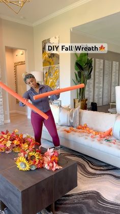 a woman is playing with some sticks in the living room