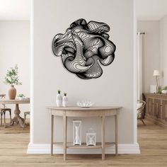 a room with a table and a clock on the wall above it is a drawing of an elephant's head