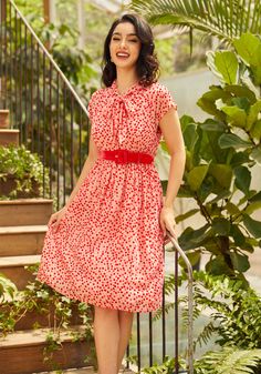 You’re a candy-coated cutie in this delightfully dazzling fit-and-flare dress from our ModCloth Namesake label ! Made from a pale pink, woven devore fabric that’s covered throughout in red and pink velvet Swiss dots, this fully-lined midi dress boasts tie-bow closure at the neck, darling cap sleeves, a removable red velvet belt, side zip closure, handy side pockets, and a high-rise waistline that leads to a gathered flare skirt that finishes sweetly below the knee. 65% Rayon, 35% Nylon Fabric pr Devore Fabric, Velvet Belt, Halloween Shoes, Plus Size Coats, Tie Bow, Re A, 1940s Fashion, 1960s Fashion, Halloween Fashion