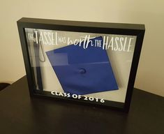 a blue graduation cap and diploma in a shadow box with the words that tassel was worth to the hasslee class of 2016