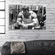 a black and white photo of a man doing squats on a bench in a gym