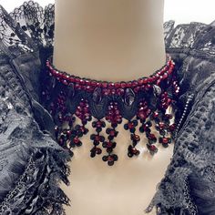 Dear customers, for a price offer of expedited shipping outside of Germany, please contact me directly via Etsy messages. Gothic Victorian Royal collar made with black lace flowers and hand sewn deep red round leafs & beads, the perfect decoration for a gothic queens neck, amazing addition for a unique gothic wedding, or even a vampire Halloween costume! Goth fashion is distinguished by darkness, mystery, elegant wardrobe pieces and, smoky makeup even though it may surprise some that not all Got Red Gothic Jewelry For Party, Red Gothic Choker For Festivals, Handmade Gothic Choker As Gift, Handmade Gothic Choker Gift, Handmade Gothic Choker For Gift, Red Choker Necklace For Halloween, Vintage Red Choker For Party, Red Beaded Choker For Party, Gothic Beaded Choker For Gifts