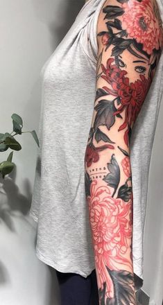 a woman's arm with flowers and birds on it