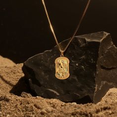 Seek solace and hope with our Gold St. Jude Pendant. Crafted in gold, this pendant features St. Jude, revered as the patron saint of hope and lost causes. The detailed design captures his serene image, making this pendant a meaningful symbol for those who value faith and perseverance. PENDANT INFORMATIONThis pendant is made of real, solid gold.• Made in USA• Material: 14k or 18k solid gold• Finish: polished• Height: 1.2" (30,5 mm) x Width: 0.7" (18 mm)• Pendant weight: approx. 6 grams (14k)• Bail: fits up to 4 mm chains• Solid back, not hollow• A certificate of authenticity is included• Delivered in our elegant jewelry box, making it the perfect gift Shipping: All of our orders are custom-made. Please allow approximately 3 weeks for production and shipping. Shipping includes a tracking num St Jude Necklace, Solid Gold Chains, St Jude, Challenging Times, Mini Pendants, Detailed Design, Box Making, Patron Saints, Memento Mori