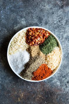 a white bowl filled with different types of spices