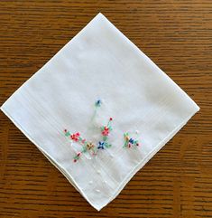 This listing is for one vintage, fine cotton handkerchief featuring brightly colored, raised flowers in hand embroidery work. It is in excellent, gently used vintage condition and has been freshly laundered.  I think it is a cotton with the border lines woven into the fabric. It measures 12 x 12 inches. The color is a white. The hem is hand rolled. Vintage Handkerchiefs, Hand Roll, Bright Flowers, Bright Colors, Hand Embroidery, Things To Think About, Scarf Accessory, Dots, Conditioner