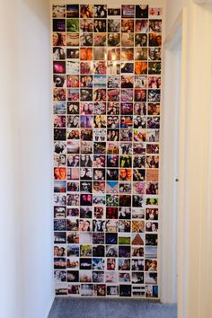 a room with a wall covered in pictures