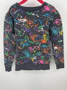 "Next Black Splatter Paint Kids Long Sleeve Crew Neck Sweatshirt Retro Sweatshirt Pullover 6-7 years 60% Cotton 40% Polyester Measurements Chest 30\" Waist 24\" Length 17.5\"" Black Paint Splatter Crew Neck Top, Multicolor Paint Splatter Crew Neck Top, Multicolor Paint Splatter Cotton Top, Multicolor Graffiti Print Sweatshirt For Winter, Multicolor Graffiti Print Winter Sweatshirt, Multicolor Graffiti Print Tops For Fall, Winter Crew Neck Sweatshirt With Graffiti Print, Winter Graffiti Print Crew Neck Sweatshirt, Multicolor Long Sleeve Sweatshirt With Graffiti Print