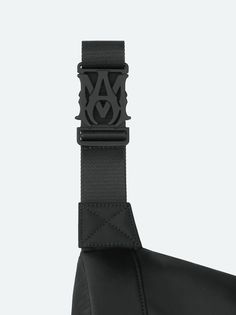 Accented with the season's embroidered AMIRI staggered logo, this utilitarian bag updates a classic silhouette through refinements in form and material. Adjustable straps with custom AMIRI hardware make this bag suitable for multiple stylings, from crossbody to belt bag wear. Pre-Spring 2024 Collection 100% NYLON DRY CLEAN ONLY Business Black Shoulder Bag With Logo Strap, Designer Black Shoulder Bag With Logo Strap, Black Leather Logo Strap For Bags, Black Leather Bag Strap With Logo, Black Luxury Shoulder Bag With Logo Strap, Designer Black Belt Bag With Detachable Strap, Luxury Black Shoulder Bag With Logo Strap, Designer Black Belt Bag With Belt Loops, Black Adjustable Strap Crossbody Bag