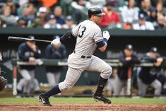 a baseball player holding a bat on top of a field in front of a crowd