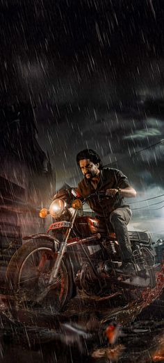 a man riding on the back of a motorcycle in the rain