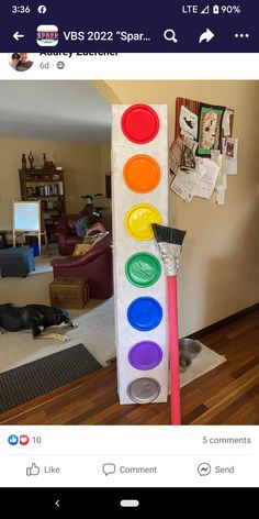 an image of a traffic light made out of paper and paintbrushes on the floor