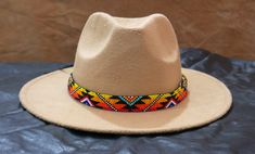 100 % Leather Hat-band is Hand Beaded with intricate beaded patterns by skilled Artisans Inspired by Native American crafting techniques and Indian beaded jewelry Beaded portion about 19.0 inches, handmade products, dimensions may slightly vary. Adjustable ties in the back. Hypoallergenic - Made with non-reactive Materials 100 percent Natural Environment friendly materials. Handcrafted with tiny Cubic Zirconia Seed Beads with beautiful and detailed beadwork. Multicolor Beaded Hats For Rodeo, Handmade Southwestern Multicolor Hats, Handmade Multicolor Southwestern Hats, Traditional Multicolor Beaded Hat Band, Handmade Southwestern Multicolor Hat Band, Beaded Brown Hat Band For Festival, Beaded Brown Hat Bands For Festival, Multicolor Bohemian Hat With Bead Caps, Festival Brown Beaded Hat Bands