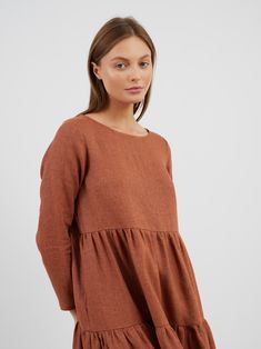 "NINA is a loose fitting, long sleeve tiered style dress. DETAILS - Midi length - Boat neckline - Tiered style - Has pockets - Long sleeve - Cut and sewn to order just for you in our studio MATERIAL - Soft and durable blend of 85% linen and 15% wool, with a weight of 230gsm COLOR - Wool Rust SIZING & FIT - Relaxed, loose fit - Model is 5'10\" / 178cm and wearing a size S CARE FOR LINEN WOOL BLEND - Machine wash up to 30ºC/86ºF gentle cycle - Lay flat to dry or tumble dry low - Warm iron if needed - Do not bleach SIZE GUIDE Size conversion guide Size XS (US 0-2, IT 36-38, UK 4-6, Japan 3-5, France 32-34) Size S (US 4-6, IT 40-42, UK 8-10, Japan 7-9, France 36-38) Size M (US 8-10, IT 44-46, UK 12-14, Japan 11-13, France 40-42) Size L (US 12-14, IT 48-50, UK 16-18, Japan 15-17, France 44-46) Casual Long Sleeve Dress For Fall Brunch, Relaxed Fit Long-sleeved Ruffle Dress, Relaxed Fit Long Sleeve Dress With Ruffles, Long Sleeve Smock Dresses For Work, Nina Long, Tiered Midi Dress, Boat Neckline, Dress Clothes For Women, Style Dress