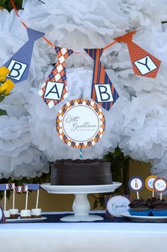 a table topped with a cake and cupcakes