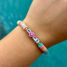 a person wearing a bracelet with words on it