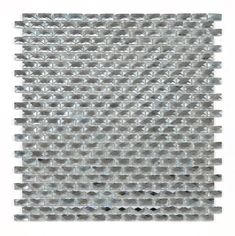 a white and gray mosaic tile pattern on a wall