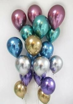 a bunch of balloons that are in the shape of a bouquet on a table with white background