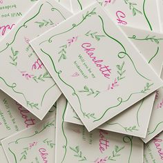 many cards with pink and green ink on them