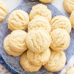 a blue plate filled with cookies on top of a marble counter