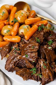 a white plate topped with meat and carrots