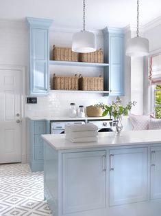 a kitchen with blue cabinets and white counter tops