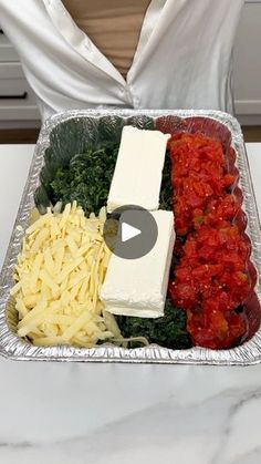 a metal tray filled with lots of different types of food on top of a table