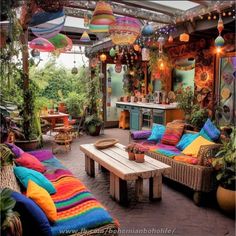 an outdoor patio with lots of colorful pillows and lights hanging from it's ceiling