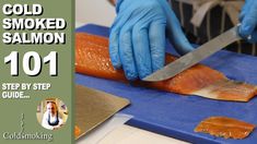 a person in blue gloves cutting up salmon