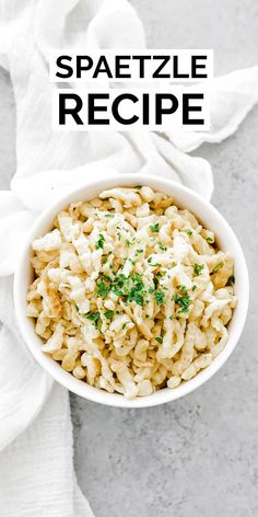 a bowl filled with macaroni and cheese on top of a white cloth next to a