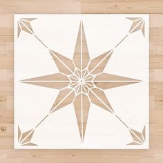 a wooden floor with a white and brown star design on the wood paneled wall