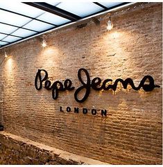 the restaurant is decorated with brick walls and black lettering that says prope jesmo london