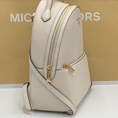 Michael Kors Women's Valerie Medium Pebbled Leather Backpack Light Cream New With The Tag Authentic Pebbled Leather Zip Fastening 9.25”W X 12.5”H X 3.75”D Front Zip Pocket Interior: Back Padded Slip Pocket, Back Zip Pocket, Front Slip Pocket Handle Drop: 1.75” Description Our Travel-Friendly Valerie Gets The Tonal Treatment For Maximum Hands-Free Style. The Pebbled Leather Backpack Features A Handy Front Pouch For Easy Access And Plenty Of Pockets Inside, Including A Dedicated Slip Pocket For Tech Essentials. Adjust The Leather Straps To Rest Comfortably On Your Shoulders. Mini Leather Backpack, Tech Essentials, Studded Backpack, Michael Kors Backpack, Light Backpack, Blue Backpack, Free Style, Light Cream, Black Backpack