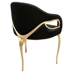 a black and gold chair with an open seat on it's back legs, viewed from the side