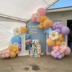 balloons and decorations are set up in front of an entrance for a children's birthday party