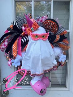 This Halloween wreath is perfect for your next hoiliday celebration. This wreath will definitely make a statement on any door. This wreath includes a handmade full body ghost girl figure, handmade lollipop picks, various ribbon, bow, mesh on a evergreen base.   This wreath can be used indoors or outdoors but is recommended to be used under a covered area to protect it from the outdoor elements. Exposure to hazardous weather may cause damage to your wreath. Ghost Wreath, Monster Front Door Decoration, Halloween Wreath Attachments, Halloween Mask Wreath, Handmade Lollipops, Halloween Centers, Monster Wreath, Witch’s Hat Wreath, Halloween Door Wreaths